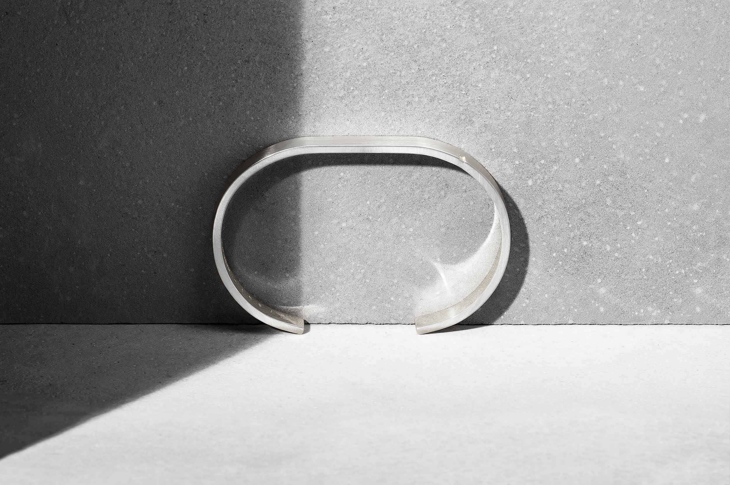 nature morte fond béton bru d'un jonc en argent 20 grammes minimaliste LE JONC